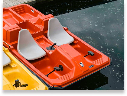 Close Up of an Orange Paddle Boat docked in the water